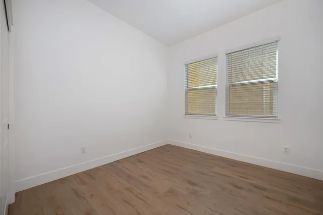 a bathroom with a double vanity sink a toilet and a mirror