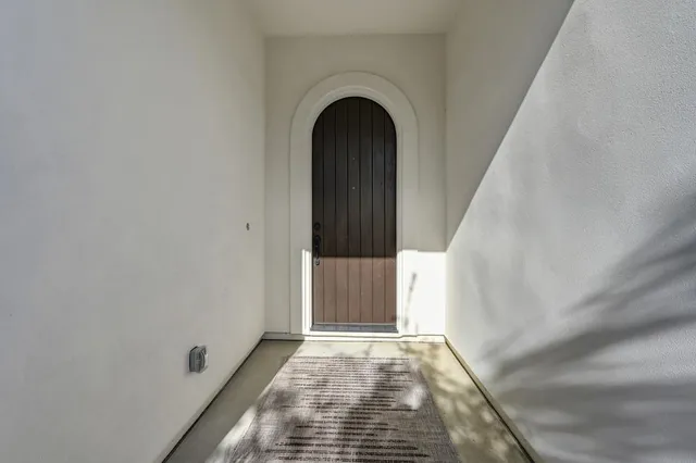 a patio with a table and chairs under an umbrella