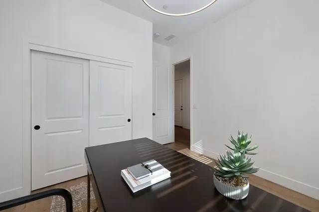 a view of patio with table and chairs under an umbrella