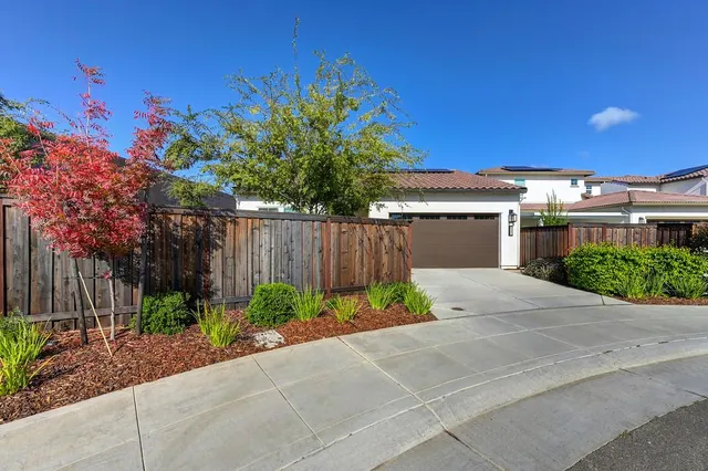 a view of a patio with couches table and chairs with potted plants