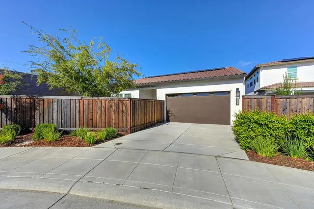a view of backyard with a table and chairs and wooden fence