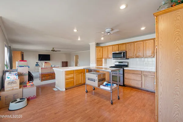 a kitchen with a refrigerator and a stove top oven