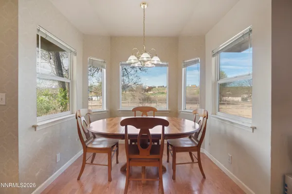 a dining room with furniture window and outside view