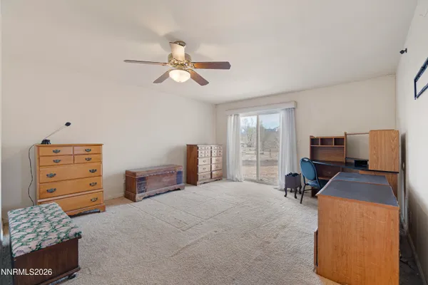 a view of workspace with furniture and a ceiling fan