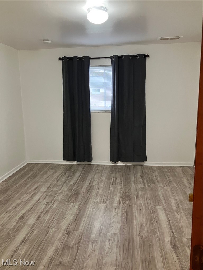 797 Babbitt Road, Unit 9 Euclid, OH 44123 - Photo 9 of 10 Spare room with wood finished floors, baseboards, and visible vents