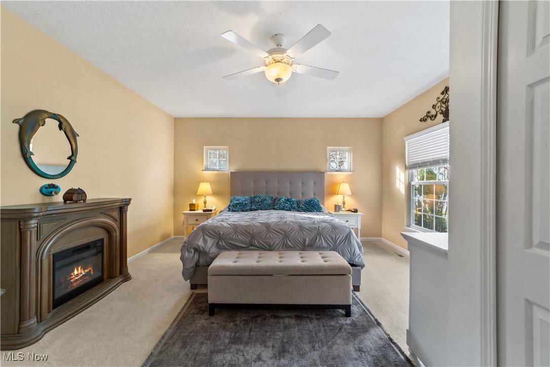 4461 Sexton Road Cleveland, OH 44105 - Photo 13 of 47 Bedroom with carpet, a glass covered fireplace, and ceiling fan