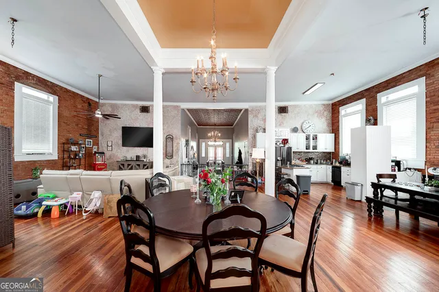 a view of a dining room with furniture window and wooden floor