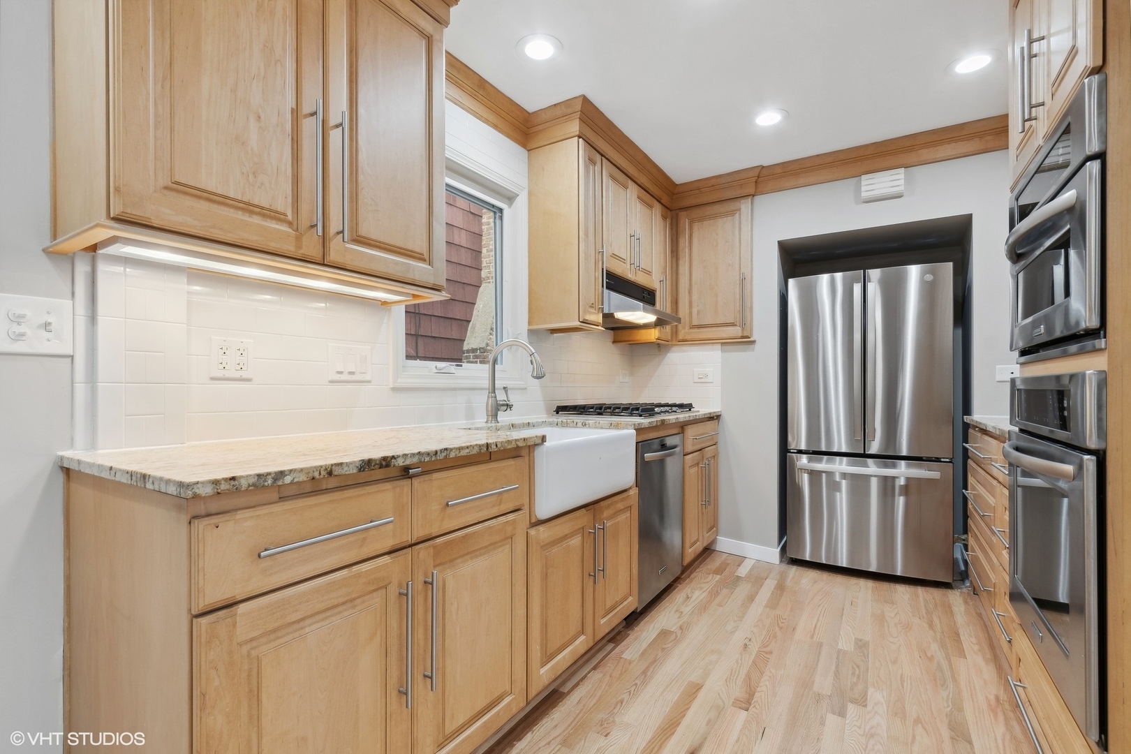 2490 Green Bay Road Highland Park, IL 60035 - Photo 6 of 29 a kitchen with granite countertop stainless steel appliances a refrigerator cabinets and wooden floor