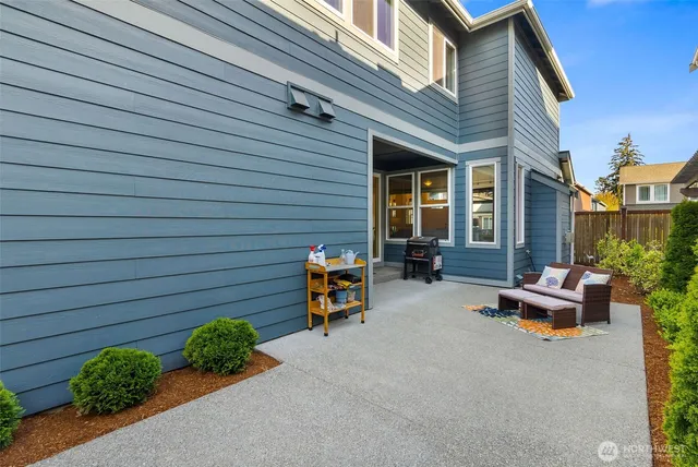a backyard of a house with outdoor seating