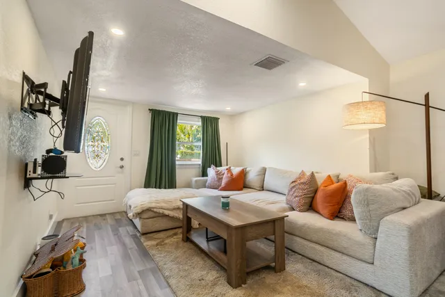 a living room with a fireplace and a flat screen tv