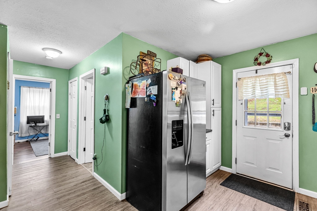 302 Middlefield Road Chester, MA 01011 - Photo 7 of 42 a view of a kitchen with refrigerator and wooden floor