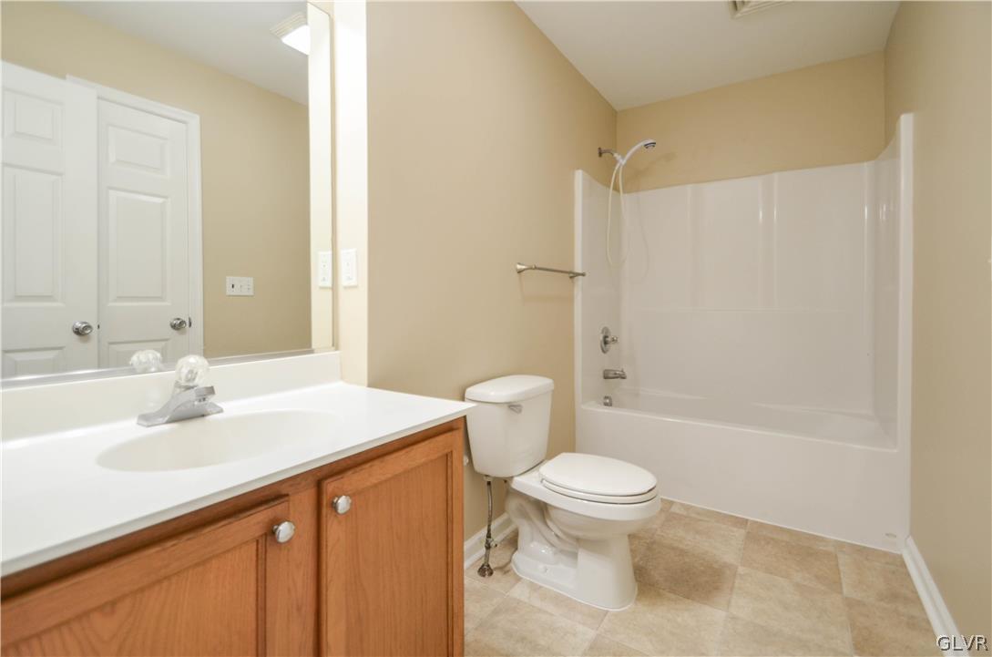 121 Sciota Garden Road Sciota, PA 18354 - Photo 26 of 31 a bathroom with a sink a toilet and a large mirror
