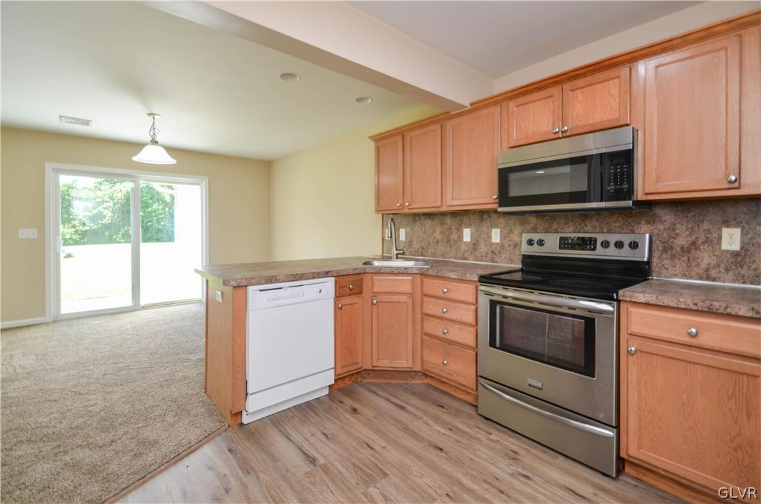 121 Sciota Garden Road Sciota, PA 18354 - Photo 7 of 31 a kitchen with stainless steel appliances granite countertop a stove a sink and a microwave