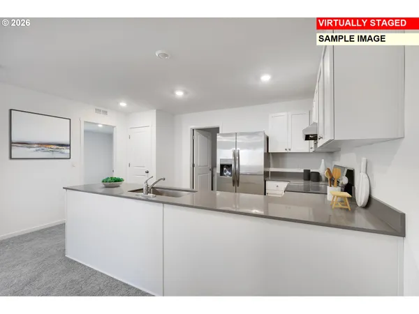 a kitchen with stainless steel appliances granite countertop a sink a stove and a refrigerator