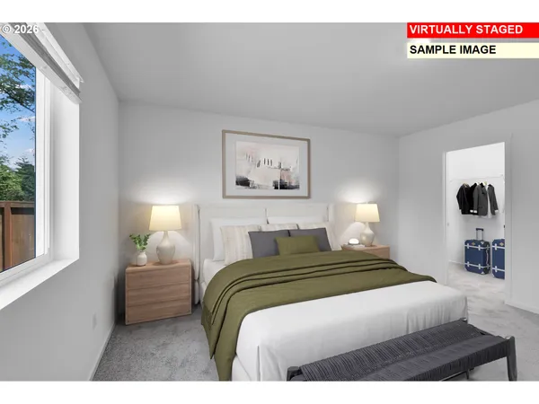 a bedroom with a bed and a large window