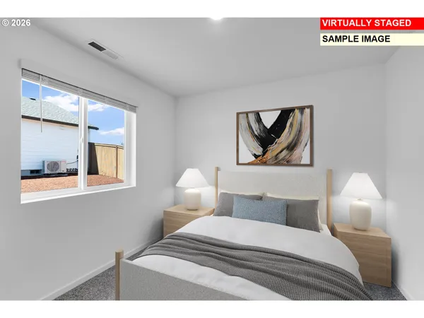 a bedroom with a bed and a painting on the wall