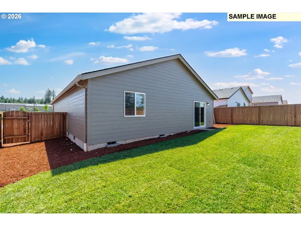a view of backyard with wooden fence