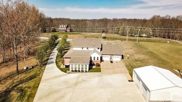 a kitchen with stainless steel appliances granite countertop a refrigerator a stove and a sink