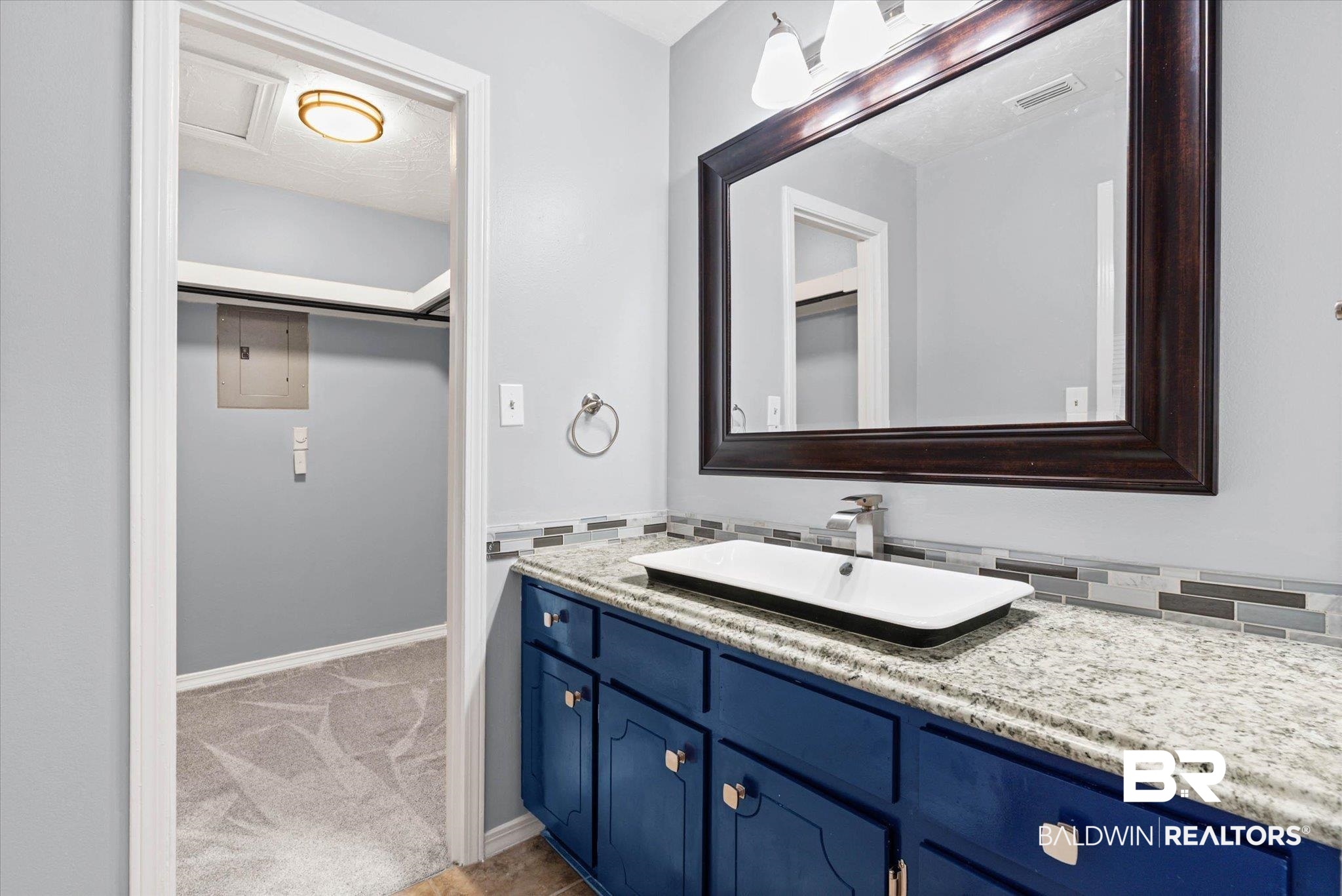 500 Grant Street, Unit C210 Daphne, AL 36526 - Photo 19 of 26 Bathroom vanity featuring a vessel sink, a granite-finish countertop, and a mosaic tile backsplash