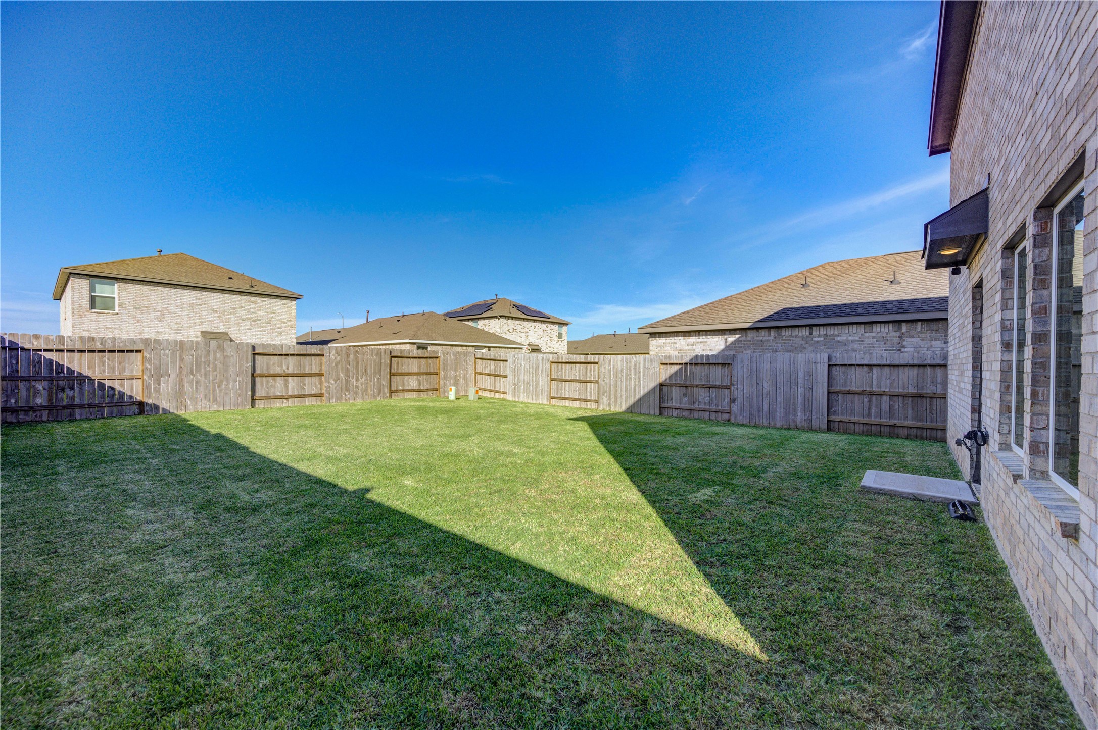 1111 Rustic Willow Drive Beasley, TX 77417 - Photo 32 of 42 Spacious, fenced backyard with well-maintained lawn, perfect for outdoor activities and privacy.