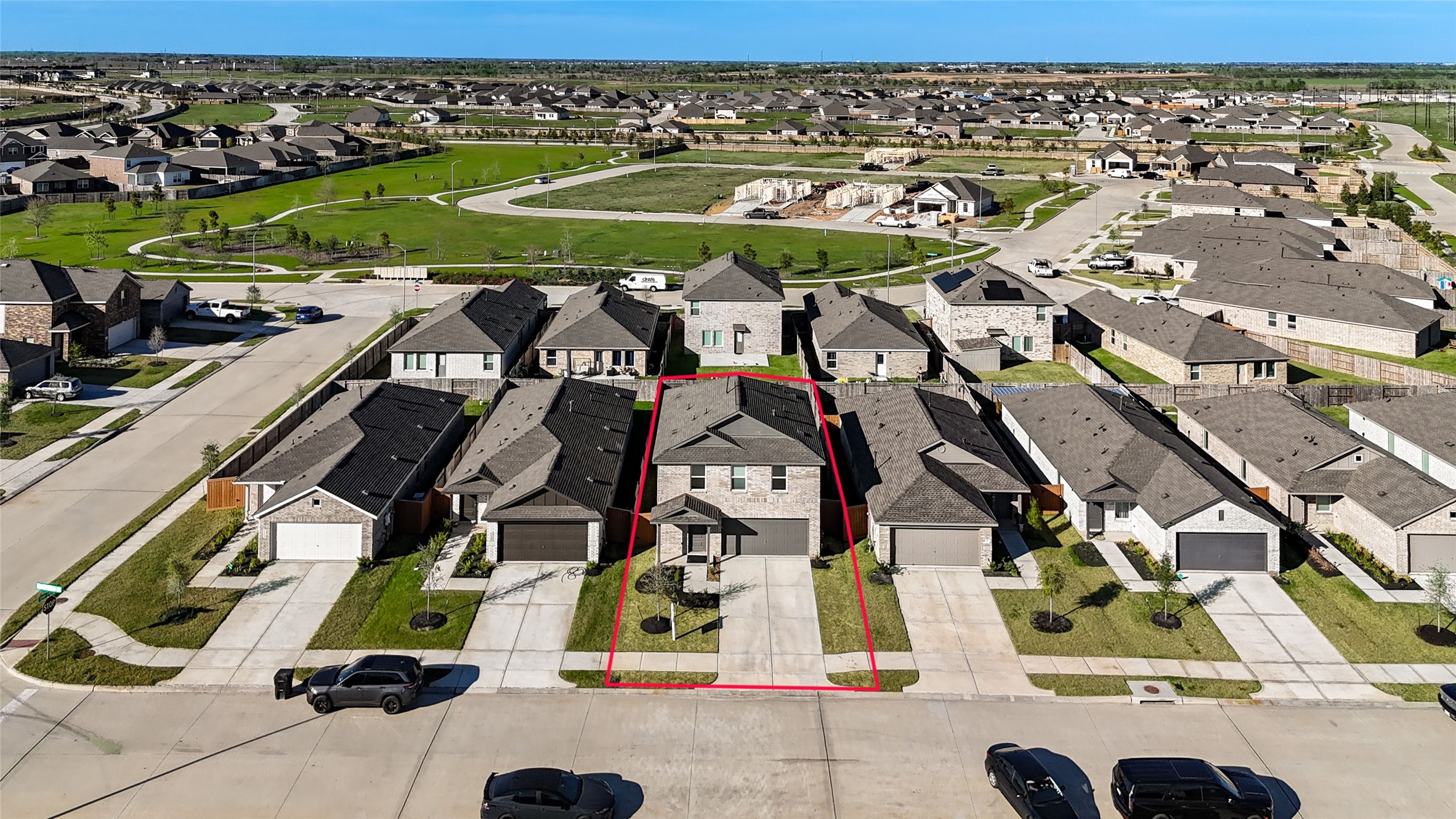 1111 Rustic Willow Drive Beasley, TX 77417 - Photo 35 of 42 This aerial photo showcases a modern, two-story home highlighted in red, nestled in a neatly arranged suburban neighborhood. The property features a driveway, a small front yard, and is located on a quiet street with easy access to nearby green spaces and amenities.
