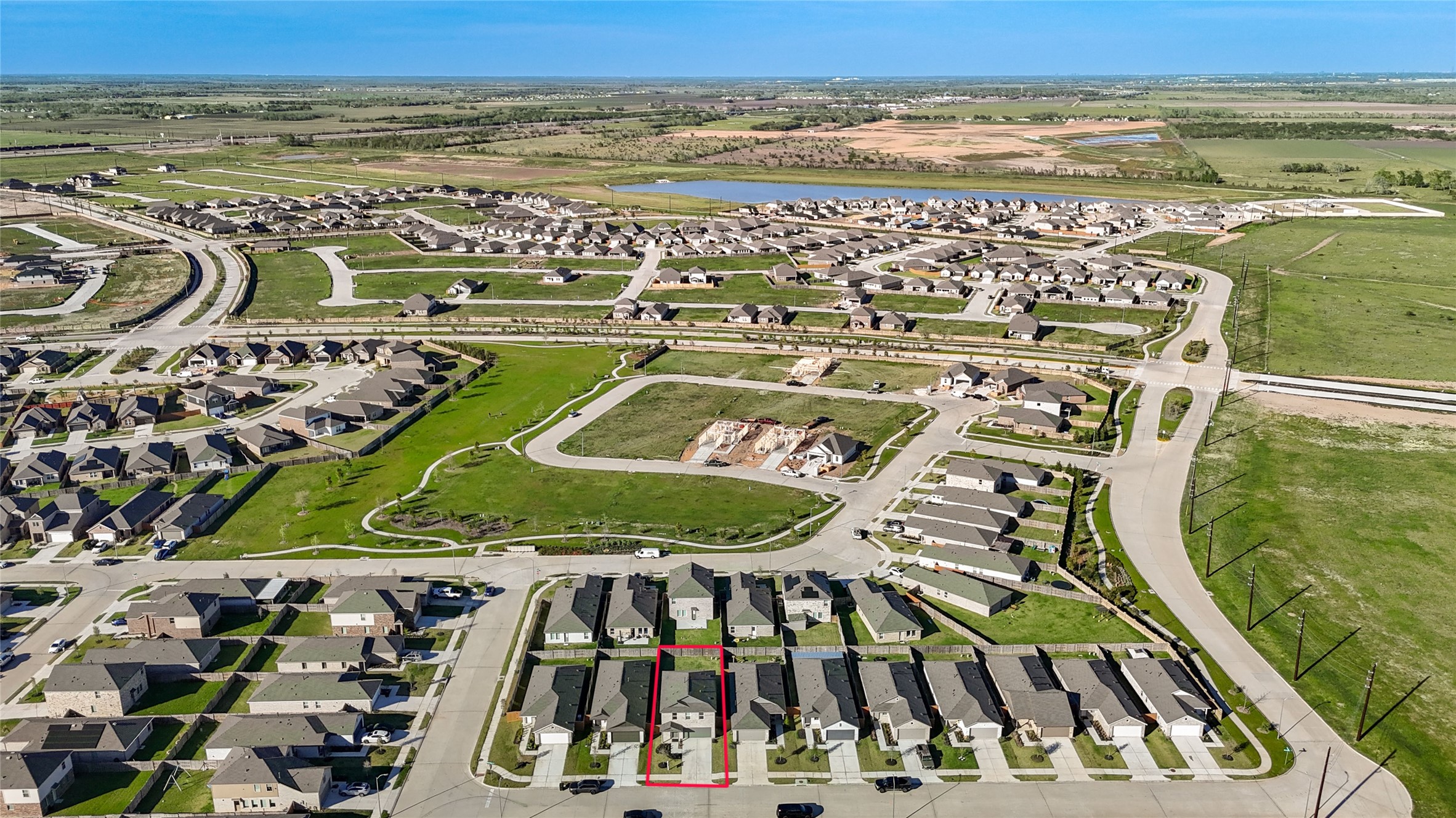 1111 Rustic Willow Drive Beasley, TX 77417 - Photo 39 of 42 This aerial photo showcases a suburban neighborhood with neatly arranged houses, well-maintained roads, and open green spaces. A specific property is highlighted, indicating its location within the community. The area is surrounded by vast fields and a distant body of water, suggesting a peaceful environment.