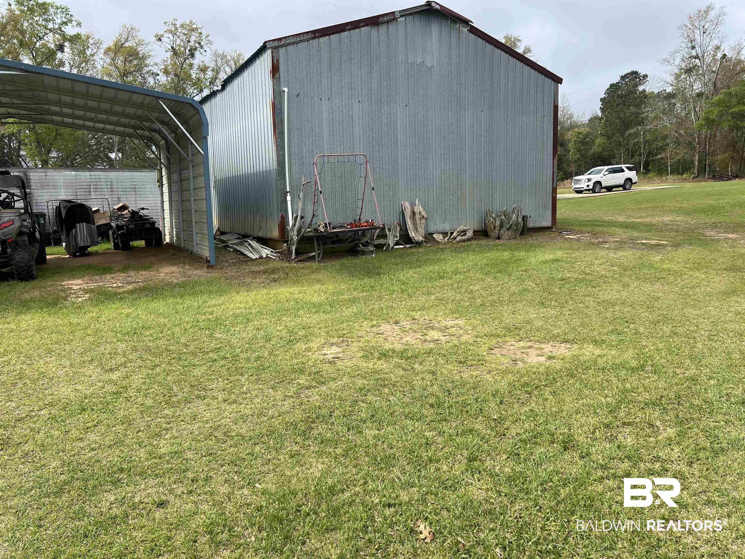 16824 Underwood Road Foley, AL 36535 - Photo 2 of 25 View of outbuilding with a lawn and a carport