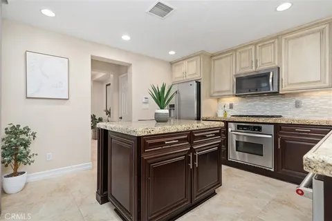 a kitchen with a sink and stainless steel appliances