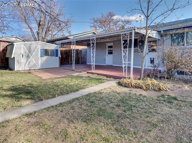 1904 North Chelton Road Colorado Springs, CO 80909 - Photo 26 of 31 Backyard and Covered Patio (w/door to garage)