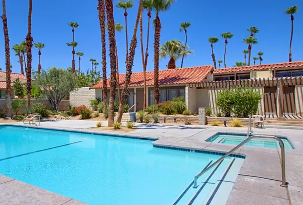 a view of a house with swimming pool and sitting area