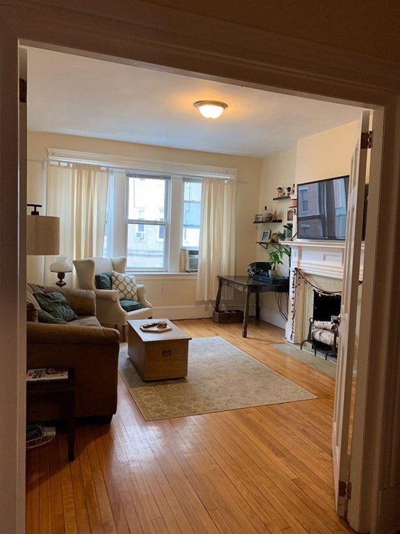 16 Royce Road, Unit 5 Boston, MA 02134 - Photo 2 of 10 a living room with furniture a fireplace and a flat screen tv