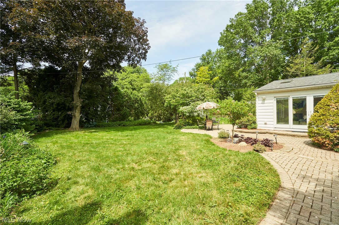 354 Tremont Road Akron, OH 44313 - Photo 32 of 34 Expansive green lawn with mature trees, bordered by a paver patio with a curved pathway