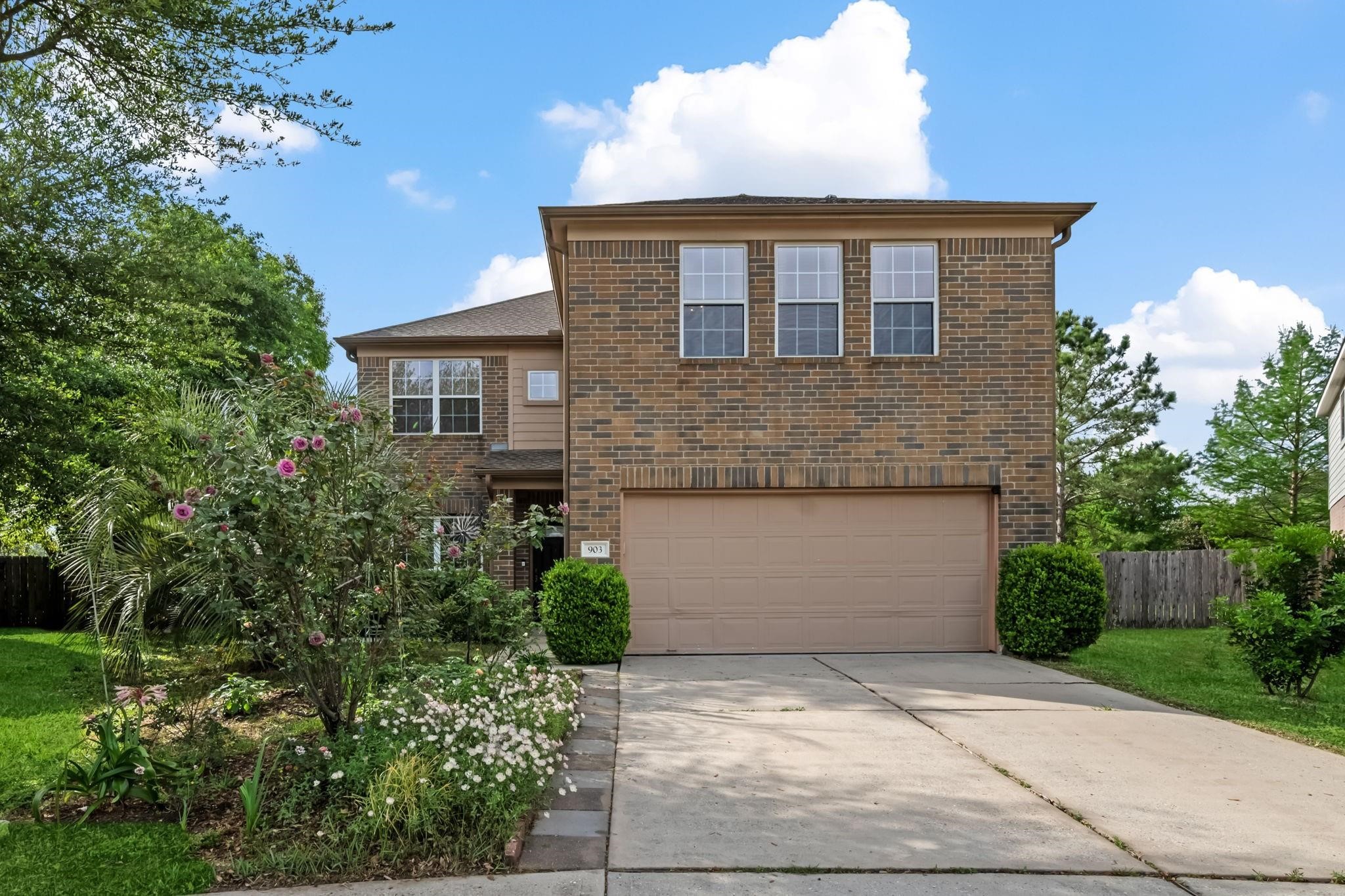 903 Northgate Springs Drive Spring, TX 77373 - Photo 2 of 36 a front view of a house with a yard and trees