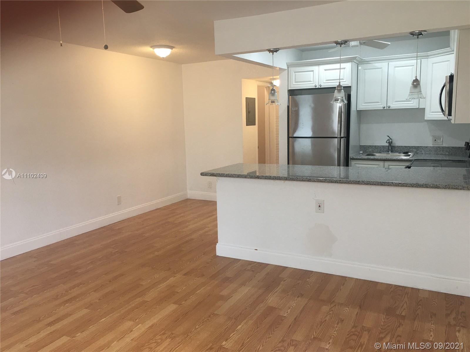 331 Farnham P, Unit 331 Deerfield Beach, FL 33442 - Photo 3 of 11 a view of a kitchen counter top space and stainless steel appliances
