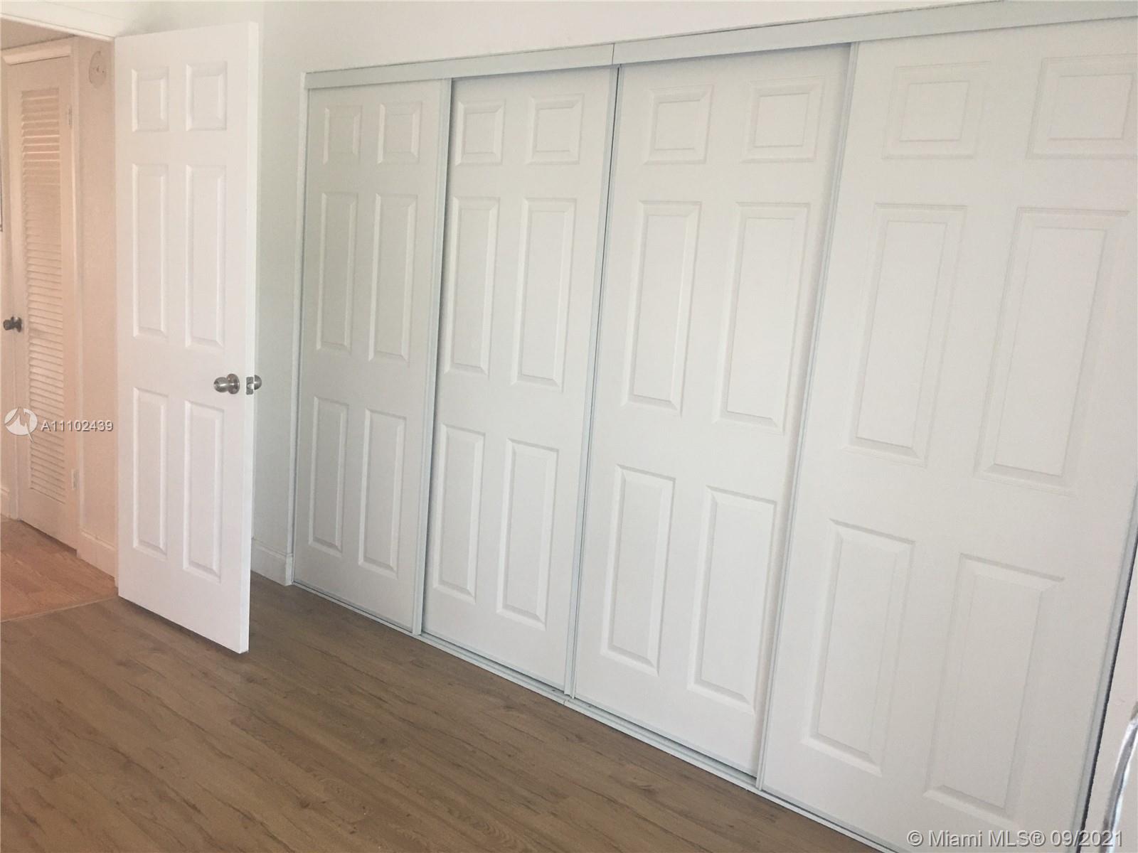 331 Farnham P, Unit 331 Deerfield Beach, FL 33442 - Photo 8 of 11 a view of a hallway with wooden floor