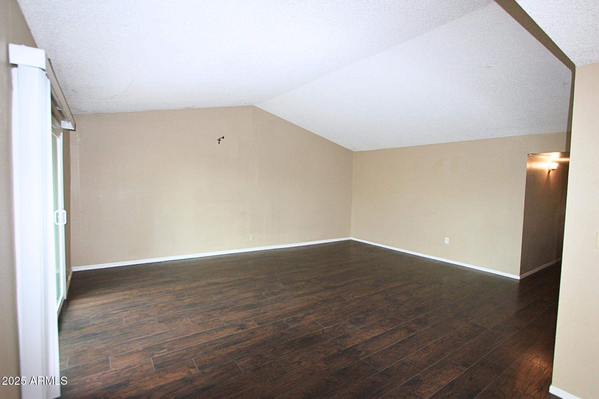 824 East Junction Street Apache Junction, AZ 85119 - Photo 2 of 9 a view of an empty room with wooden floor