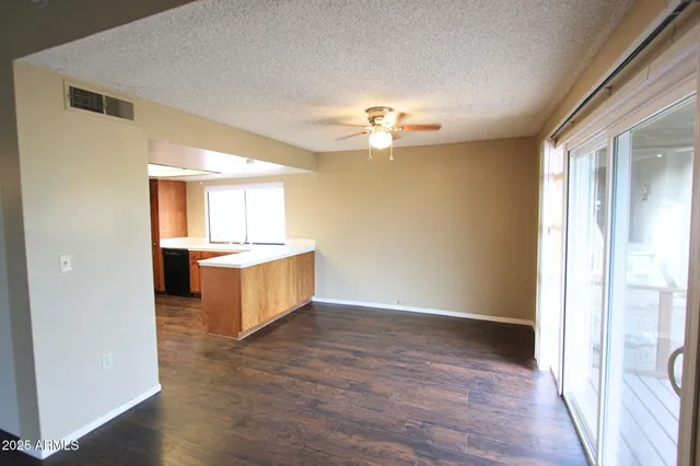 an empty room with a kitchen and a sink