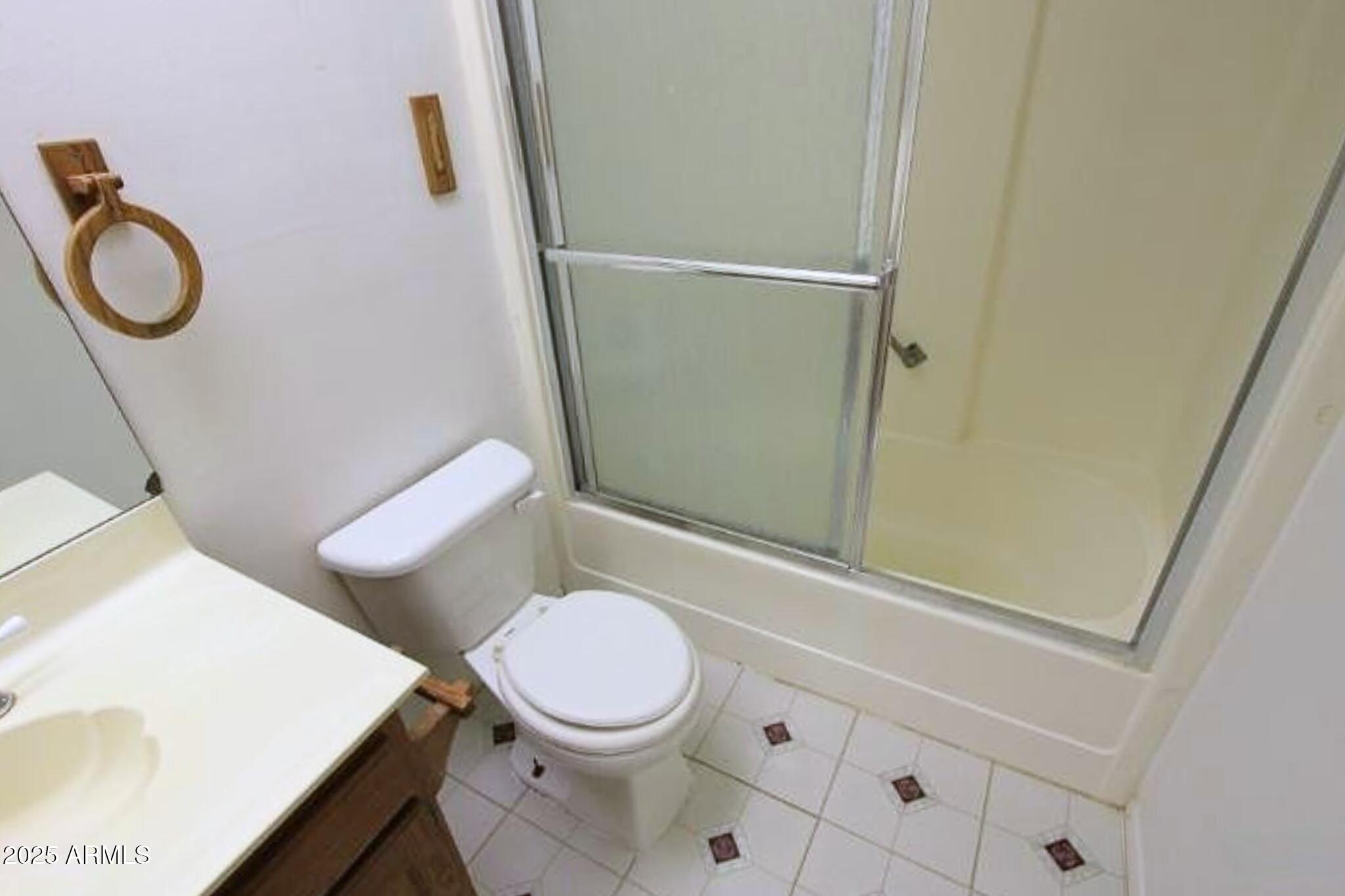 824 East Junction Street Apache Junction, AZ 85119 - Photo 7 of 9 a white toilet sitting next to a bathroom sink and vanity