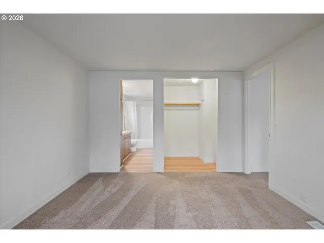 a bathroom with a granite countertop sink a toilet a mirror and shower