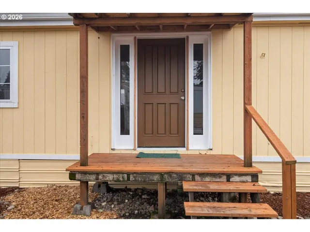 a kitchen view with a table and chairs