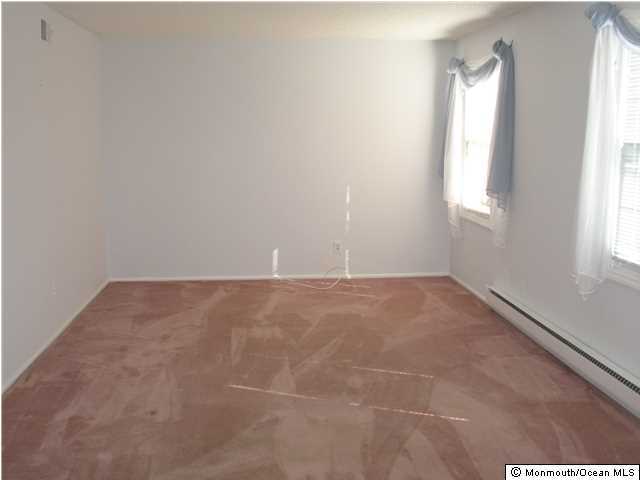 95 Halls Croft Road, Unit A Freehold, NJ 07728 - Photo 4 of 15 an empty room with windows