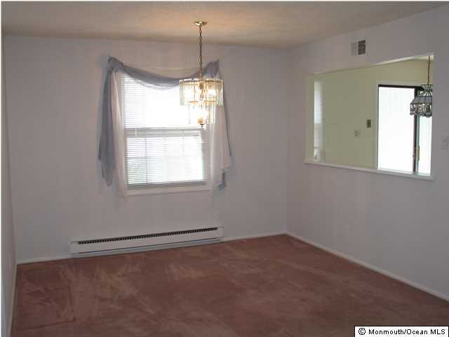 95 Halls Croft Road, Unit A Freehold, NJ 07728 - Photo 5 of 15 an empty room with a window