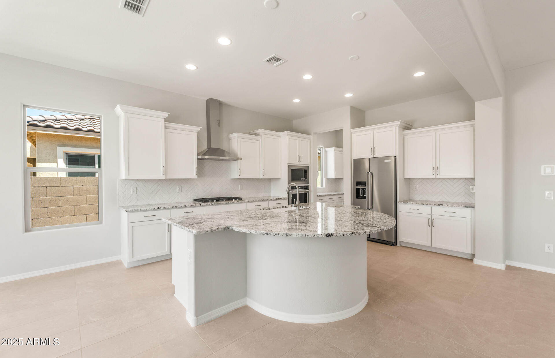 7836 West Mockingbird Way Florence, AZ 85132 - Photo 11 of 37 a kitchen with stainless steel appliances a refrigerator sink and stove