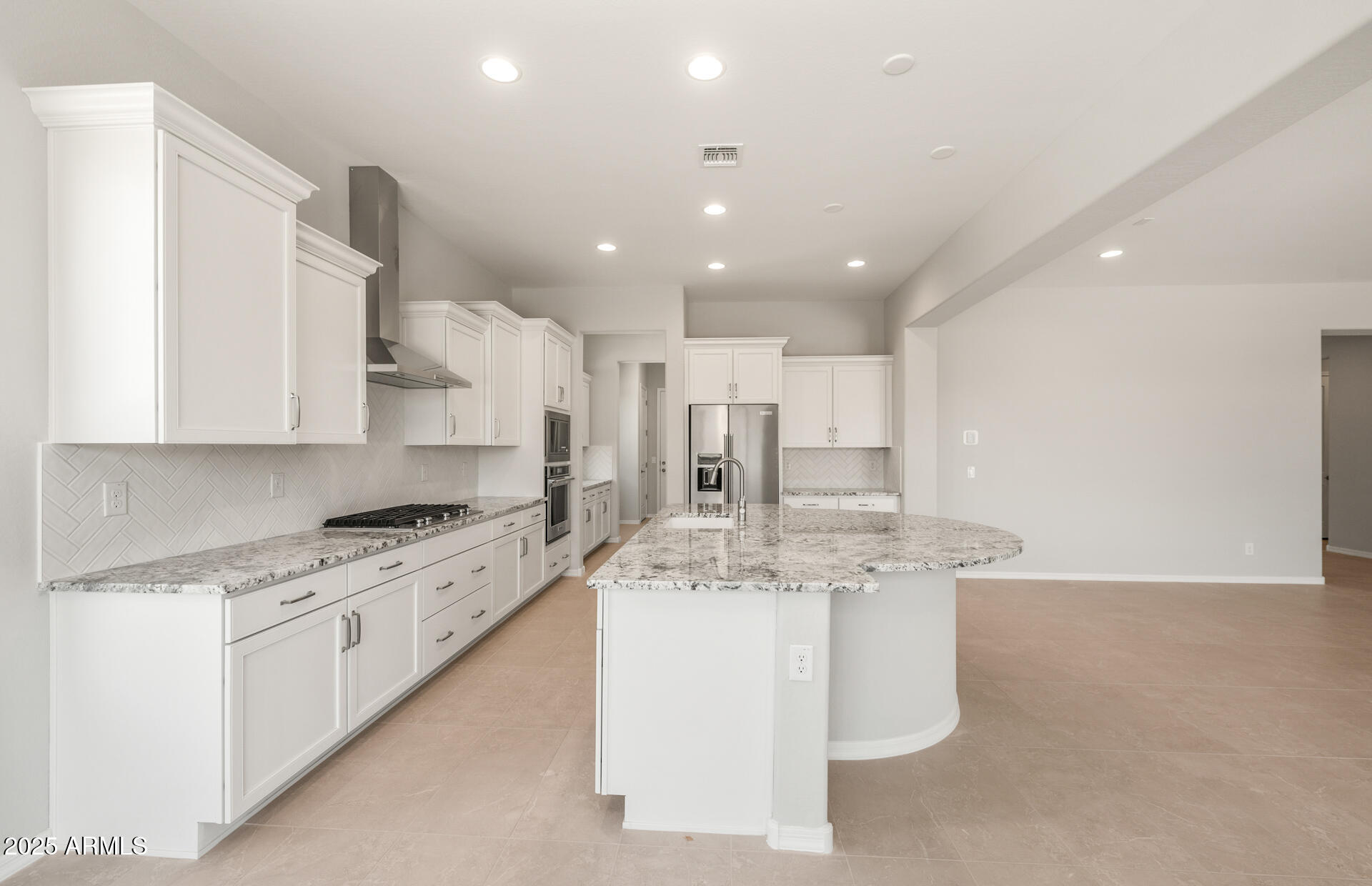 7836 West Mockingbird Way Florence, AZ 85132 - Photo 12 of 37 a large white kitchen with stainless steel appliances granite countertop a stove a sink a refrigerator and white cabinets