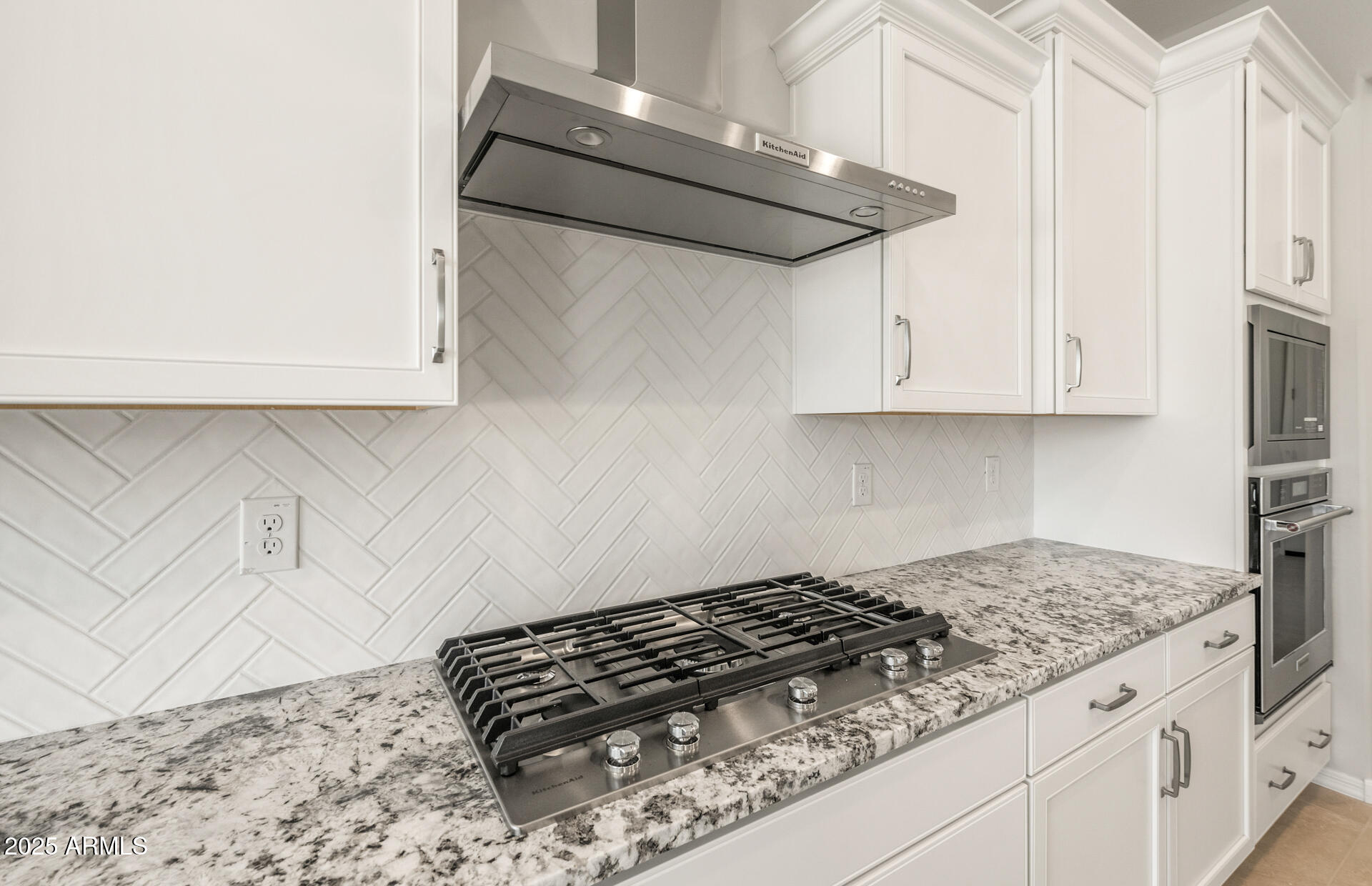 7836 West Mockingbird Way Florence, AZ 85132 - Photo 13 of 37 a kitchen with granite countertop white cabinets and a stove top oven