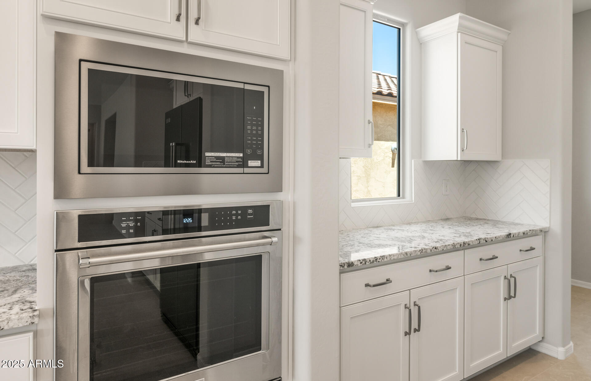 7836 West Mockingbird Way Florence, AZ 85132 - Photo 17 of 37 a kitchen with granite countertop white cabinets and white appliances