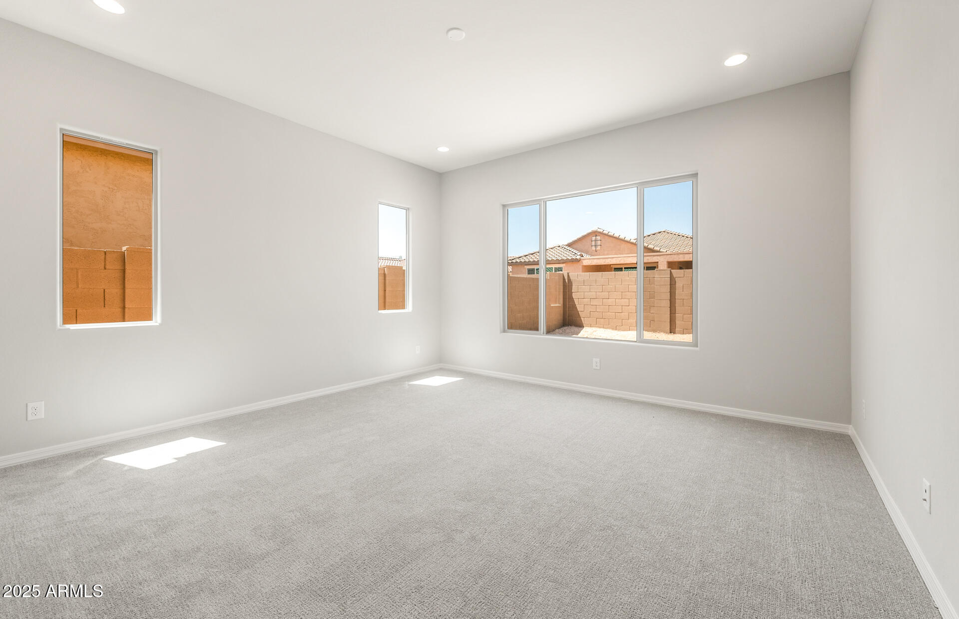7836 West Mockingbird Way Florence, AZ 85132 - Photo 21 of 37 an empty room with chandelier fan and windows