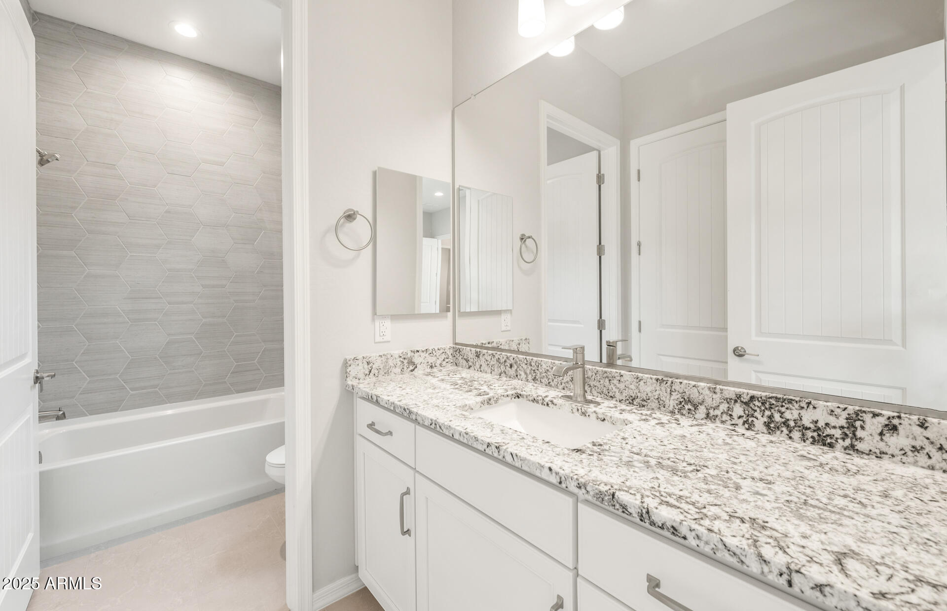 7836 West Mockingbird Way Florence, AZ 85132 - Photo 4 of 37 a bathroom with a granite countertop sink and a bathtub
