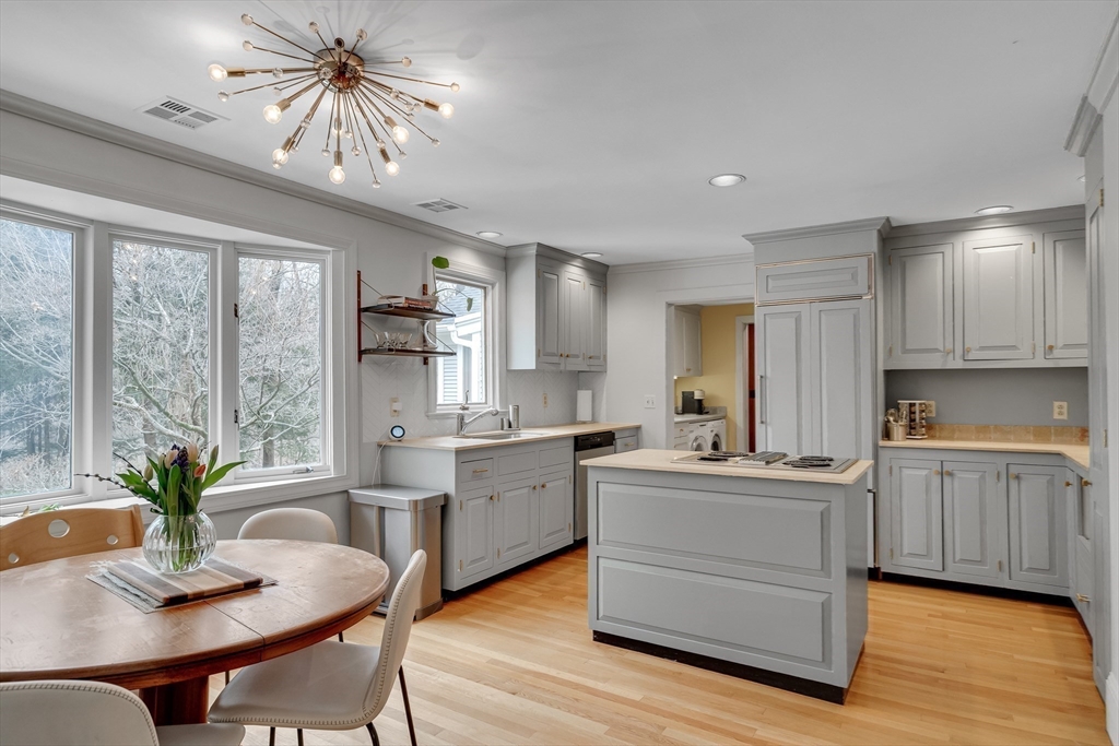 215 Mossman Road Sudbury, MA 01776 - Photo 12 of 30 a kitchen with a table chairs refrigerator and cabinets