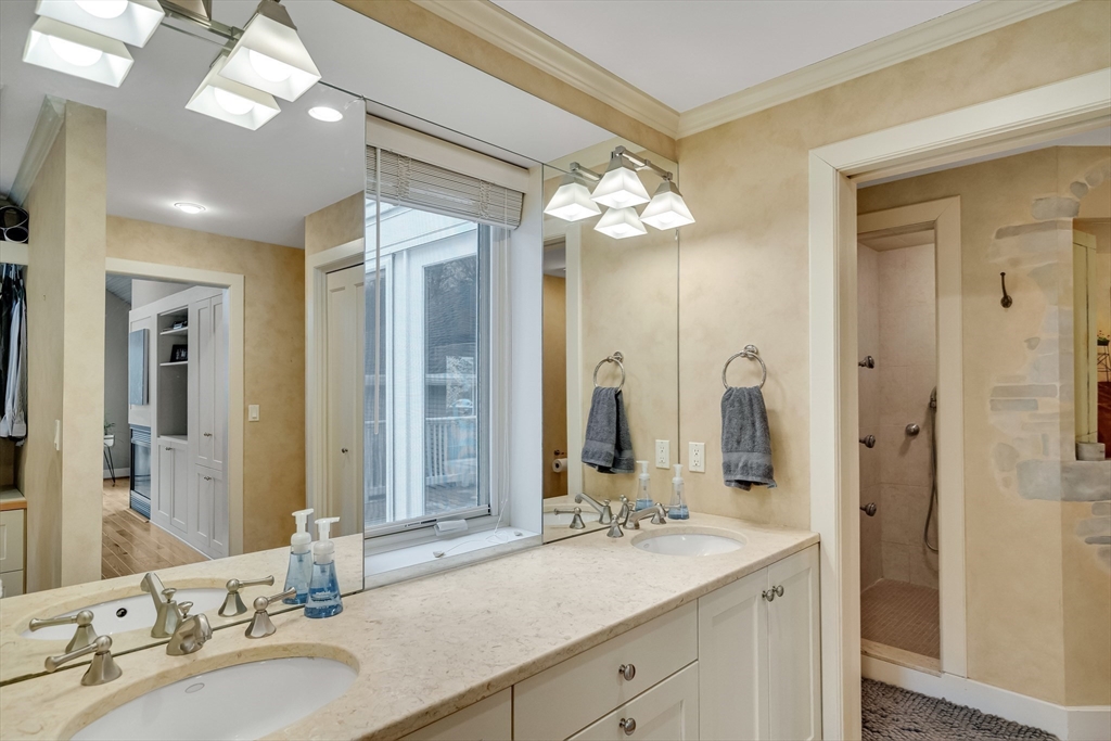 215 Mossman Road Sudbury, MA 01776 - Photo 17 of 30 a bathroom with a double vanity sink and a mirror